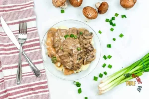 Instant pot salsbury steak with mushrooms and green onions and a red and white napkin