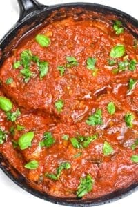 steak pizzaiola in a cast iron pan