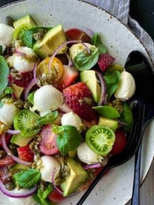 tomato mocconcini salad in a bowl with red and green cherry tomatoes
