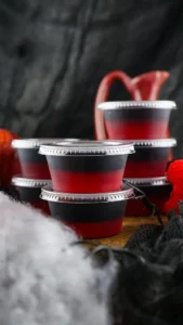 vampire kiss fireball jello shots in plastic containers stacked up