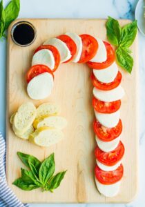 candy cane shaped cheese and tomato board