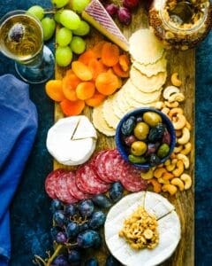 holiday charcuterie board with fruit, meats, cheese and nuts