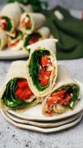 Spinach feta wraps cut in half on a stack of plates