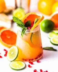 grapefruit margarita with citrus and mint garnish and sliced citrus