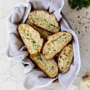 Garlic cheese bread in a bowl with a napkin