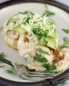 chorizo gravy over biscuits with avocado and cilantro