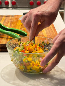 mango avocado salsa being stirred