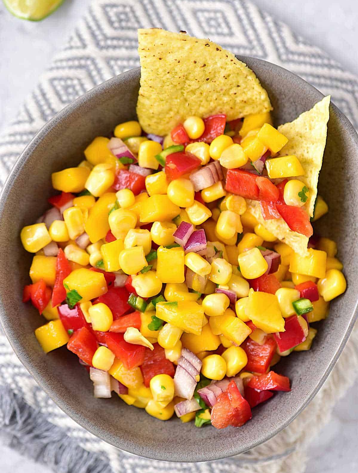 bowl of mango and corn salsa with chips