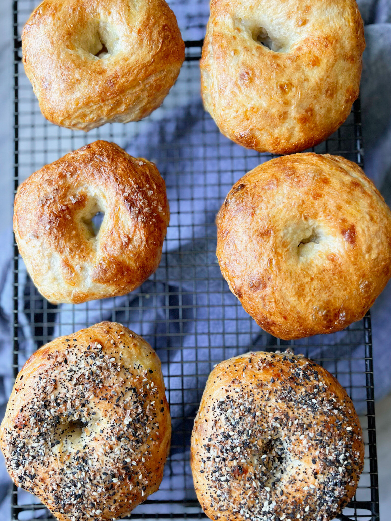 bagels on a cooling rack with a blue napkin