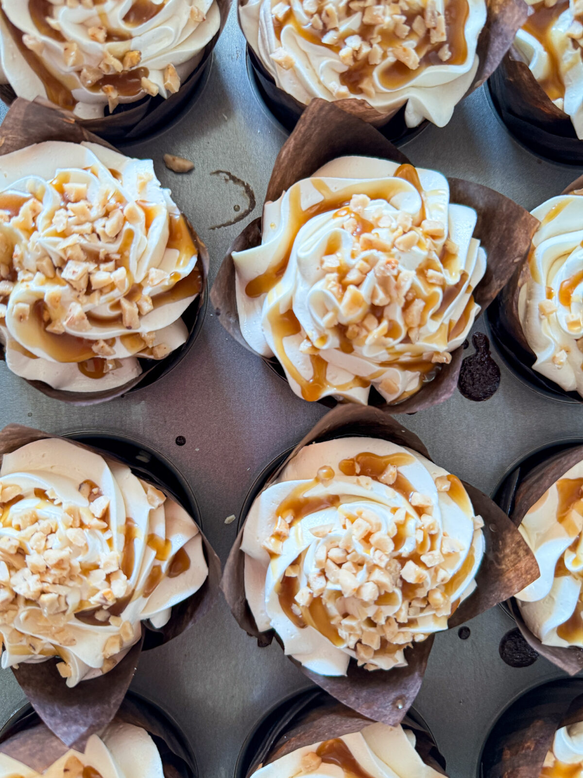 Pumpkin cupcakes with cream cheese frosting and bourbon caramel frosting and toasted pecans