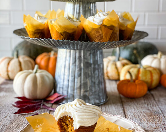 a tower of pumpkin cupcakes with cream cheese frosting