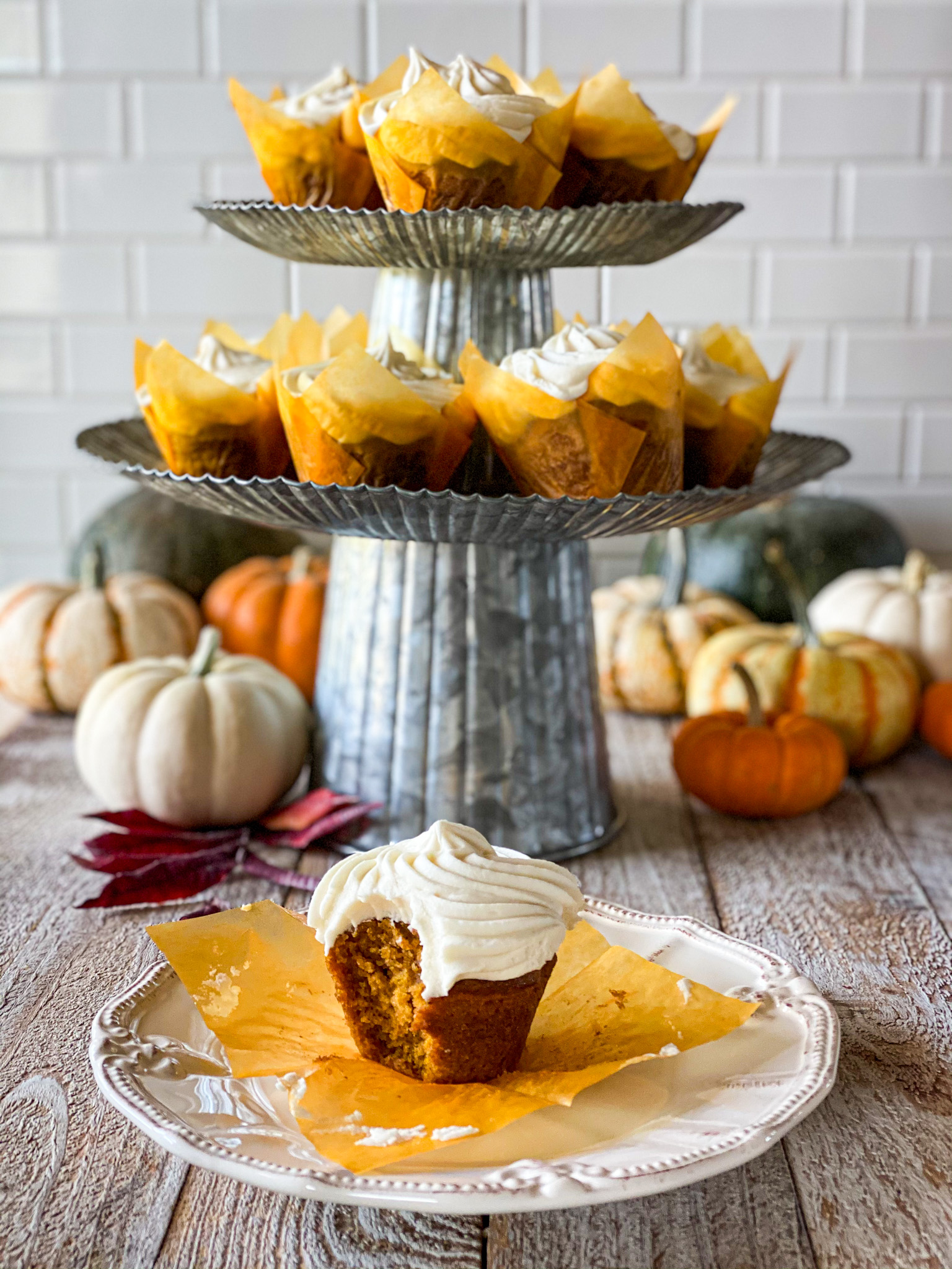 a tower of pumpkin cupcakes with cream cheese frosting