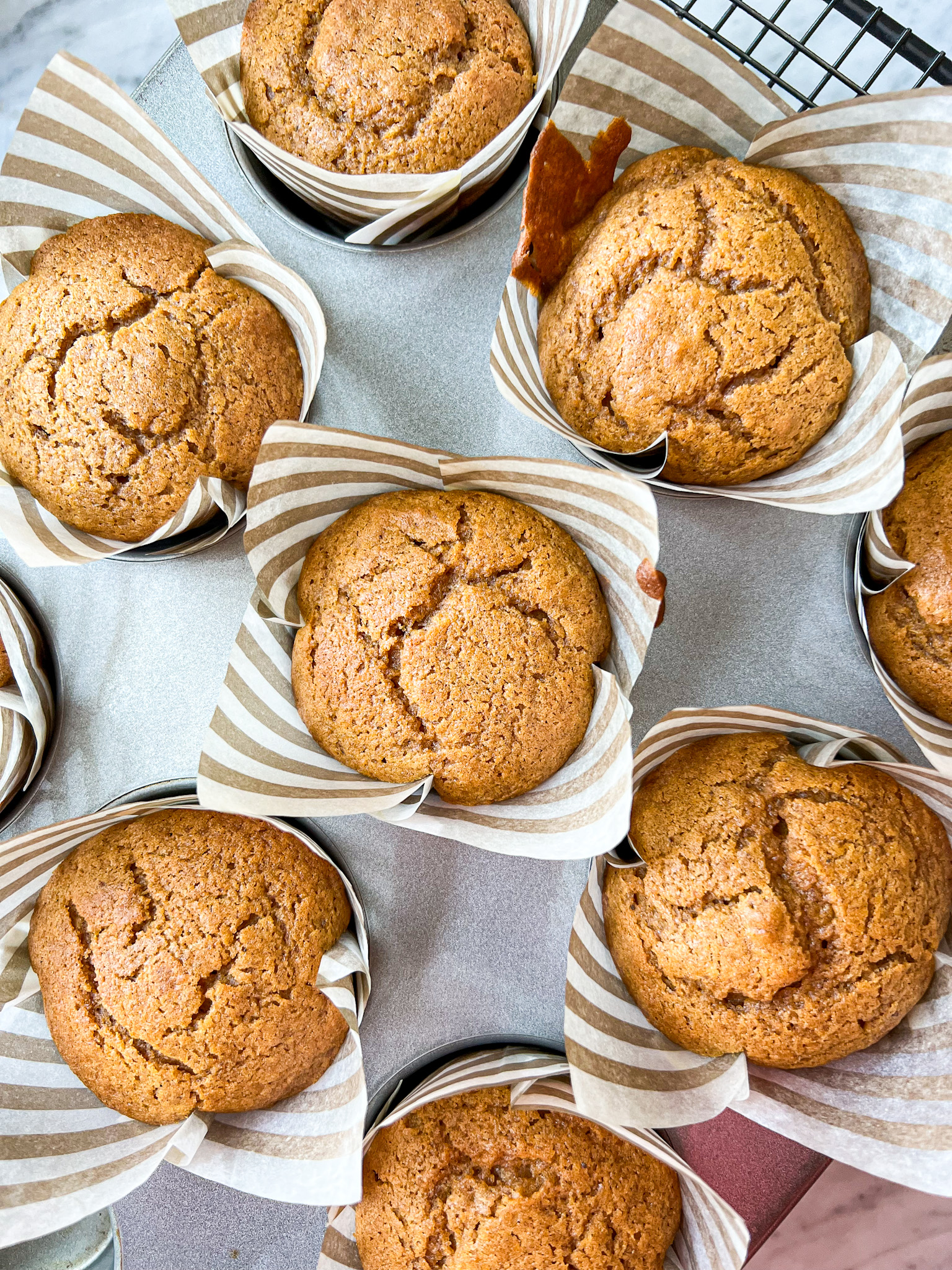 pumpkin cupcakes unfrosted in a muffin tin