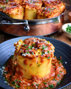 butternut squash lasagna roll ups in a pan and on a plate