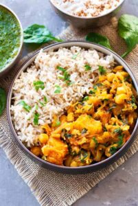 butternug squash and chickpea curry in a bowel with rice and herbs