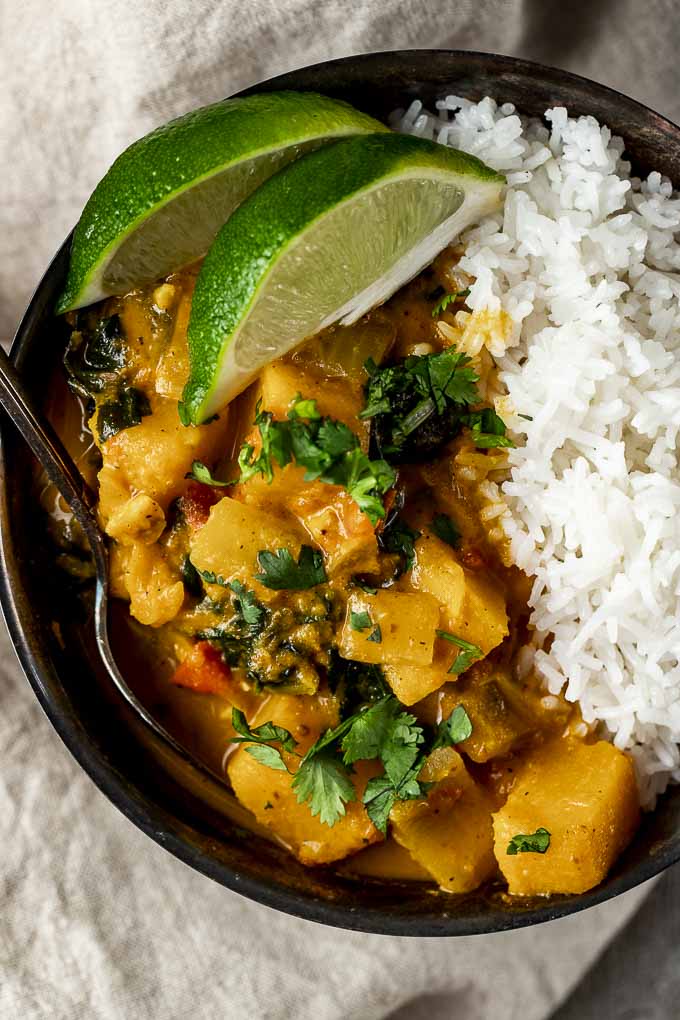 Butternut Squash curry in a bowl with rice and lime wedges