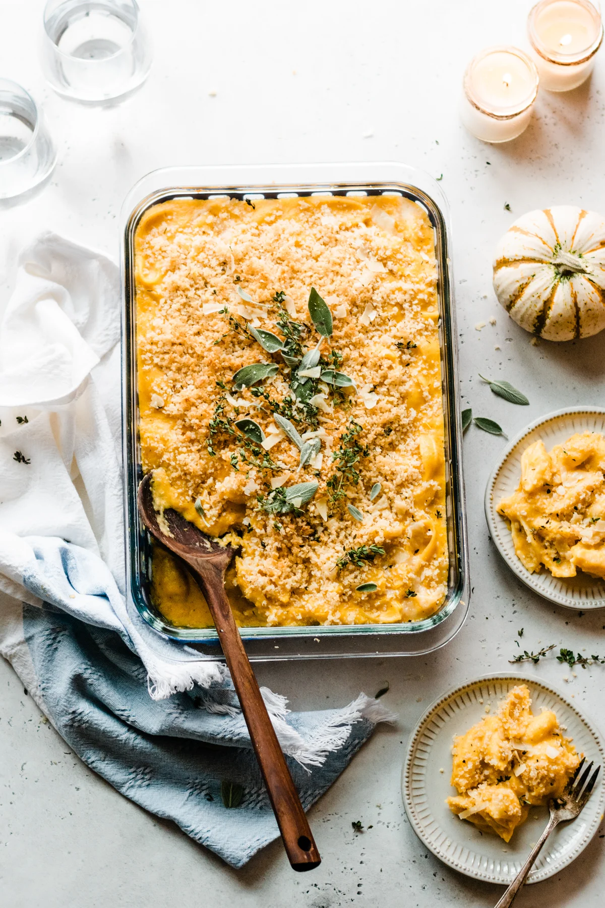 Butternut squash mac n cheese in a caserole pan with mini pumpkin