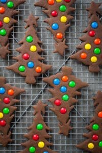 gingerbread trees with m&m candies on a cooling rack