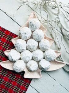 Russian Tea Cakes on a Christmas Tree platter with red napkin