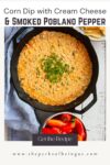 corn dip in a cast iron pan with chips and peppers in bowls