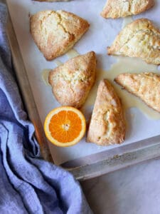 Orange scones with glaze and a blue napkin