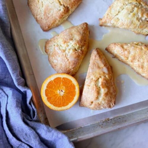 Orange scones with glaze and a blue napkin