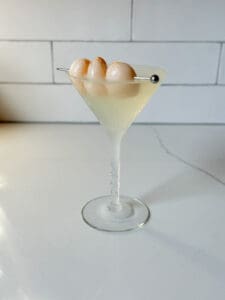 Lychee martini with 3 lychees as garnish