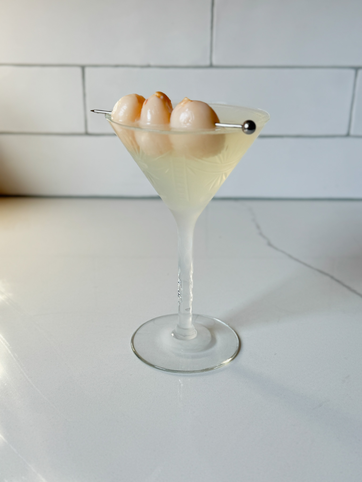 Lychee martini with 3 lychees as garnish