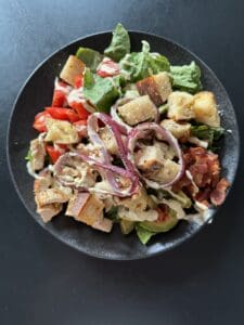 california blt caesar salad on a black plate