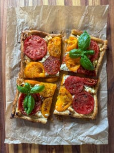 A goat cheese tomato tart cut into 4 pieces