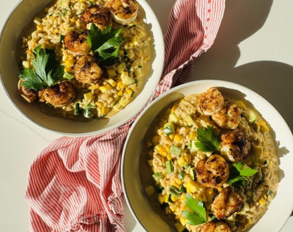 2 bowls of corn and zucchini and summer squash risotto and a red and white napkin