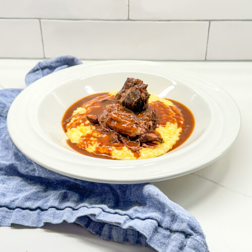 Pot roast served over grits with gravy