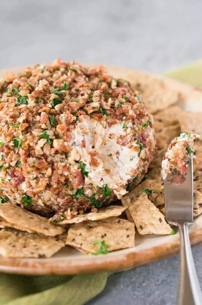 bacon ranch cheese ball on a plate with crackers