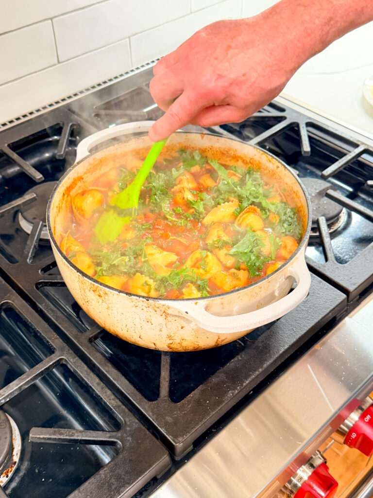 soup with kale stirred, on a stove