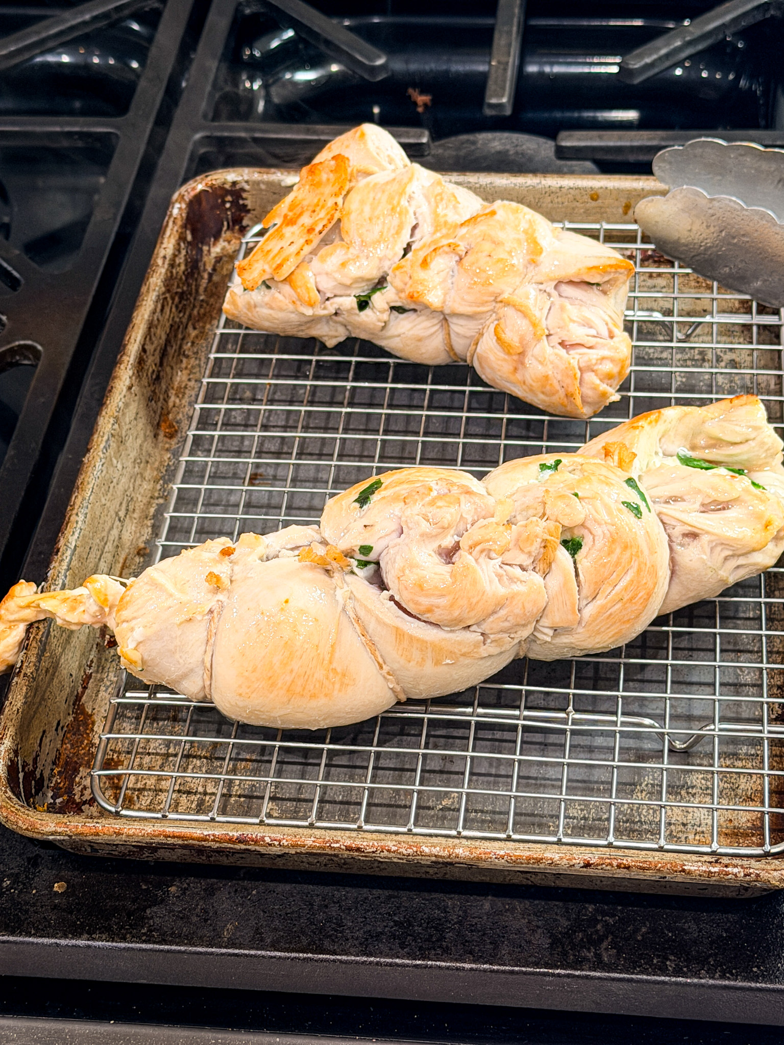 browned chicken resting on a wire rack