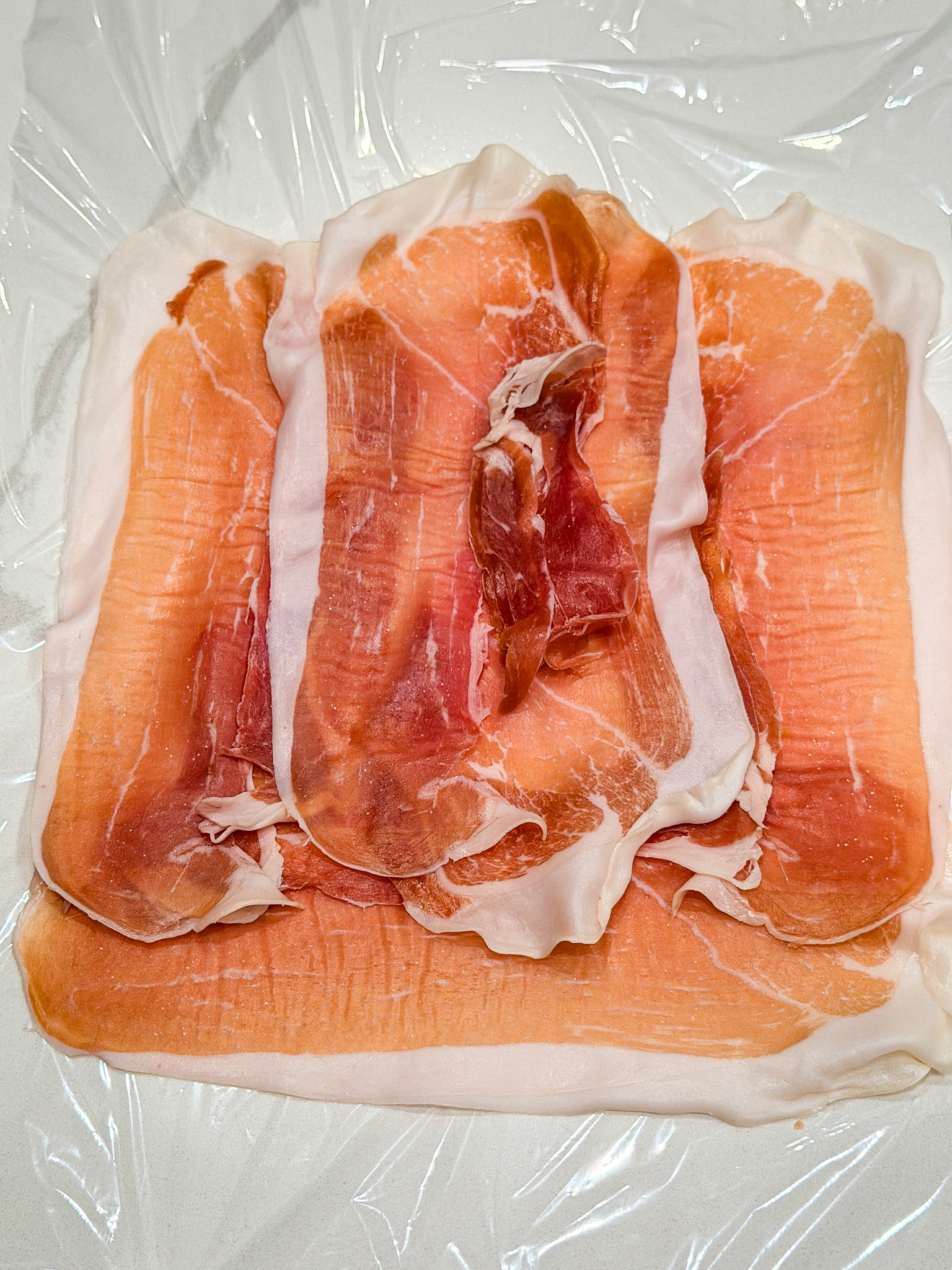 proscuiotto on plastic wrap