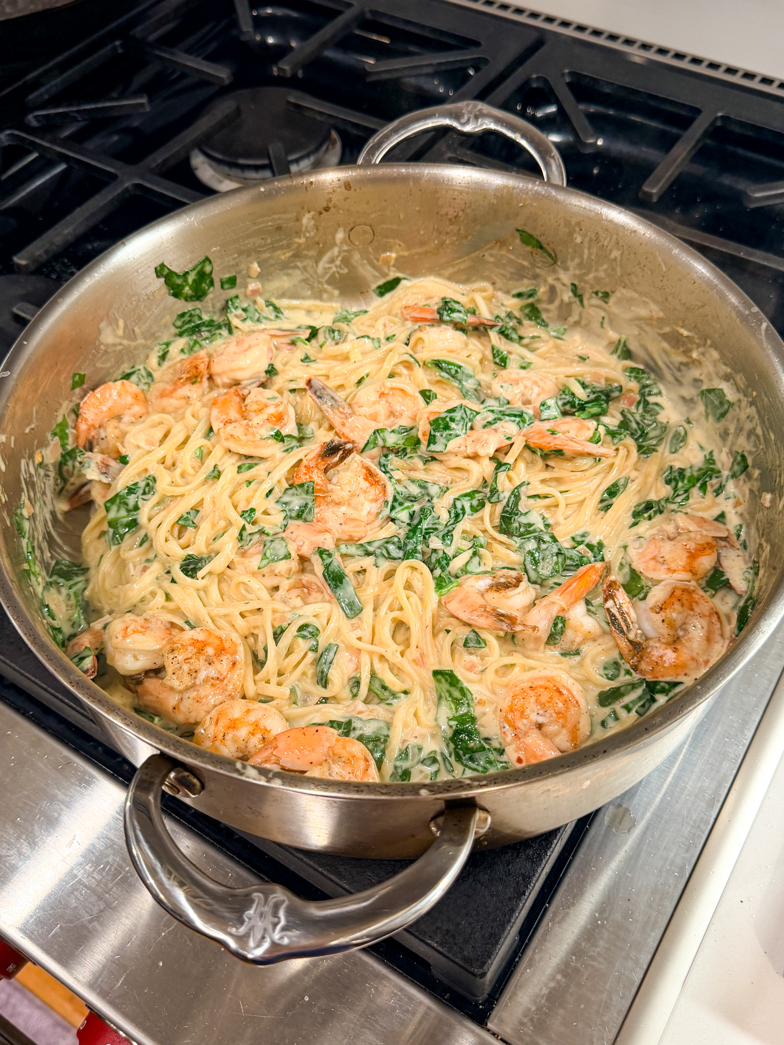 Shrimp linguine with spinach in a pan