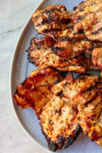 Grilled chicken thighs on q blue platter
