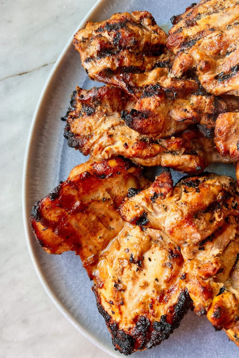 Grilled chicken thighs on q blue platter